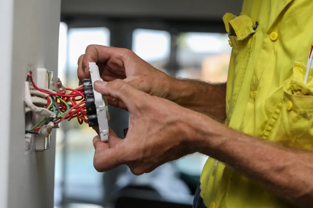 Electrician performing electrical repairs and installations as a service