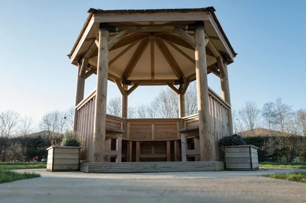 Professional handyman installing and repairing an outdoor gazebo to enhance a residential backyard