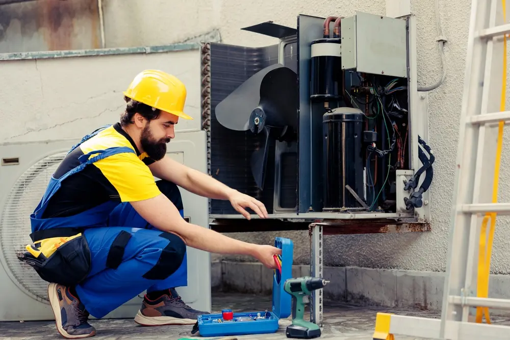 HVAC technician inspecting and servicing a heating and cooling system to ensure efficient operation