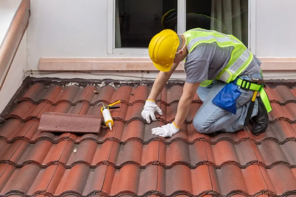 Professional inspecting and repairing a residential roof to improve durability and weather protection